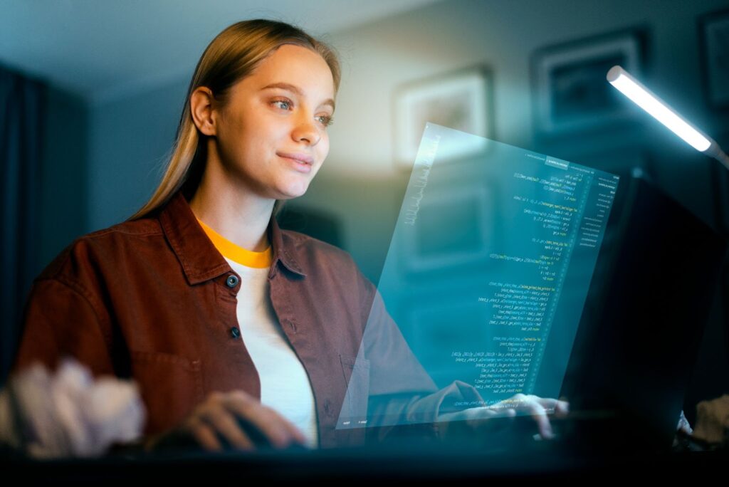 Woman working on laptop with code