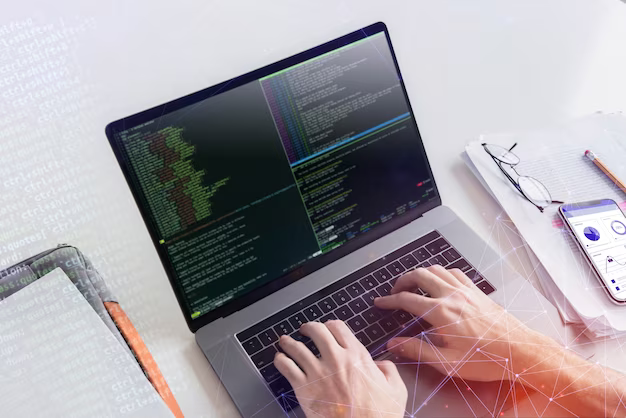 Man's hands on a laptop keyboard writing code