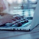 A man does programming on a laptop